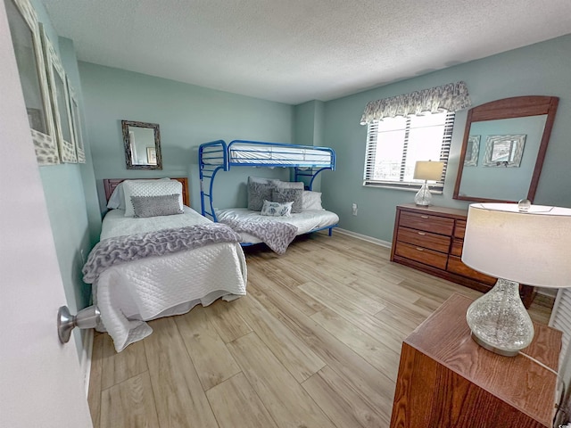 2101 S Ocean Blvd Unit A-4, North Myrtle Beach, SC 29582 - bedroom featuring wood finished floors, a textured ceiling, and baseboards