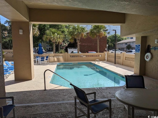 3000 N Ocean Blvd Unit 1406, Myrtle Beach, SC 29572 - community pool featuring a patio and a fenced backyard
