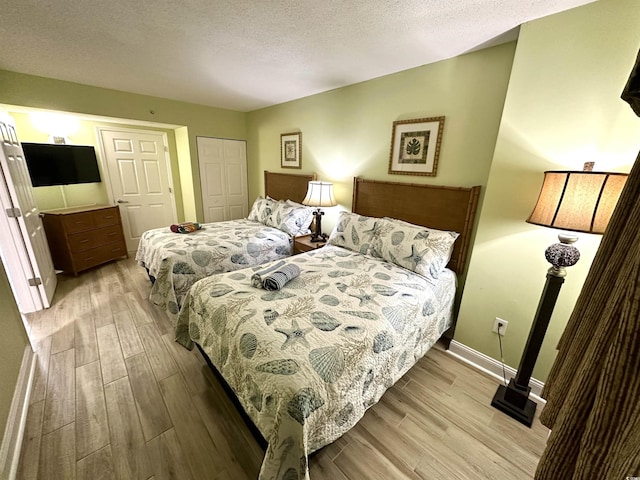 3000 N Ocean Blvd Unit 1406, Myrtle Beach, SC 29572 - bedroom featuring light wood finished floors, a textured ceiling, baseboards, and a closet