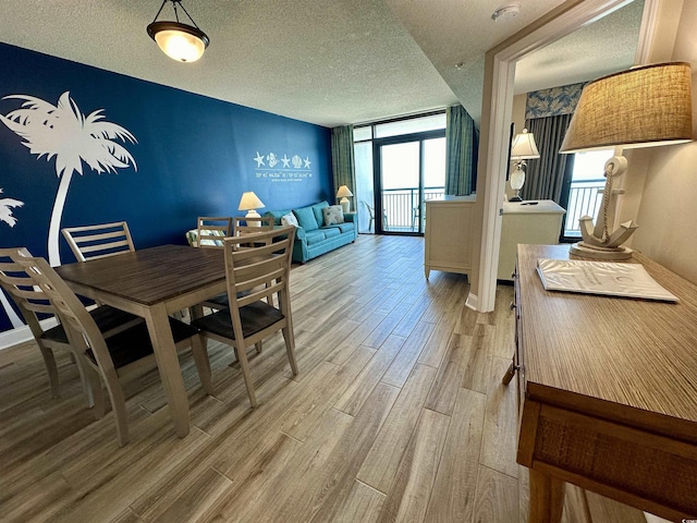 3000 N Ocean Blvd Unit 1406, Myrtle Beach, SC 29572 - dining room with healthy amount of natural light, light wood finished floors, a textured ceiling, and baseboards