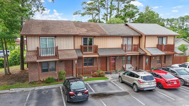 218 Waccamaw Village Dr Unit 218, Myrtle Beach, SC 29579 - townhome / multi-family property with uncovered parking, roof with shingles, brick siding, and a balcony