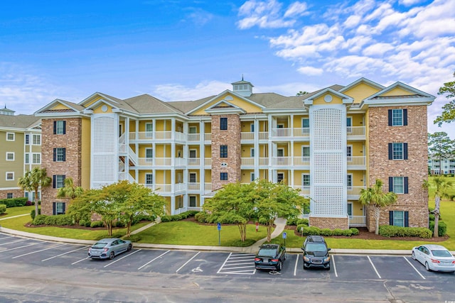 4890 Luster Leaf Cir Unit 201, Myrtle Beach, SC 29577 - view of building exterior featuring uncovered parking