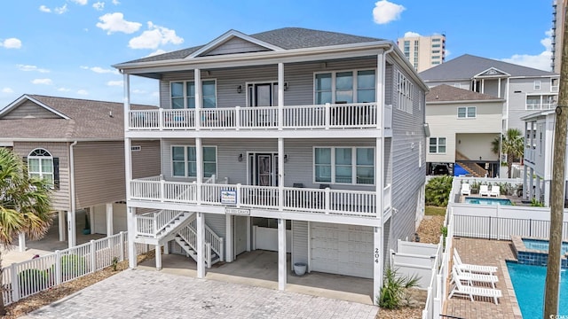 204 33rd Ave N, North Myrtle Beach, SC 29582 - coastal inspired home with a balcony, an attached garage, and decorative driveway