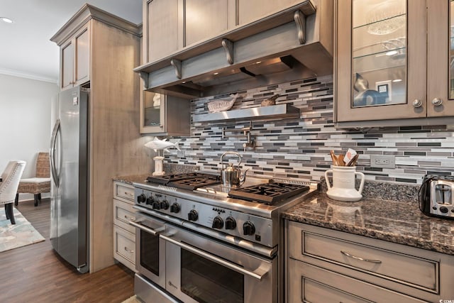 204 33rd Ave N, North Myrtle Beach, SC 29582 - kitchen featuring stainless steel appliances, crown molding, tasteful backsplash, dark wood-style flooring, and glass insert cabinets