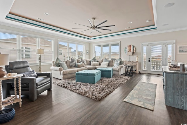 204 33rd Ave N, North Myrtle Beach, SC 29582 - living room featuring a raised ceiling, ceiling fan, ornamental molding, healthy amount of natural light, and dark wood-type flooring