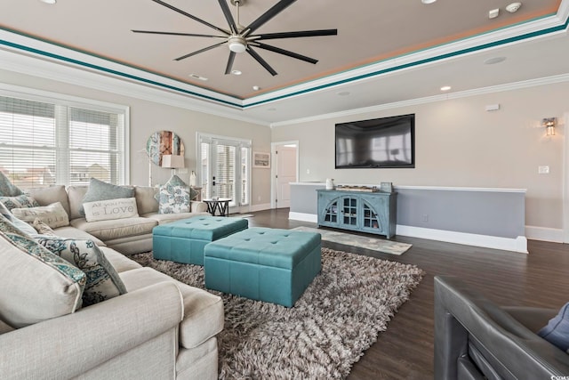 204 33rd Ave N, North Myrtle Beach, SC 29582 - living room featuring a ceiling fan, dark wood finished floors, a tray ceiling, baseboards, and ornamental molding