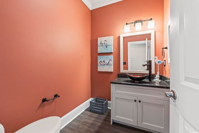 204 33rd Ave N, North Myrtle Beach, SC 29582 - half bath with toilet, ornamental molding, vanity, baseboards, and wood finished floors