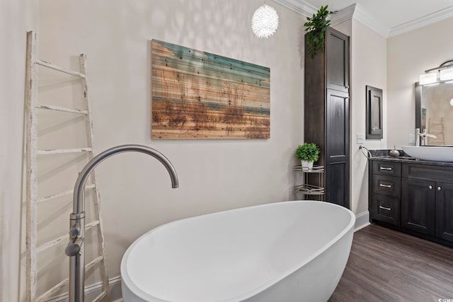 204 33rd Ave N, North Myrtle Beach, SC 29582 - bathroom with vanity, a freestanding tub, crown molding, wood finished floors, and baseboards