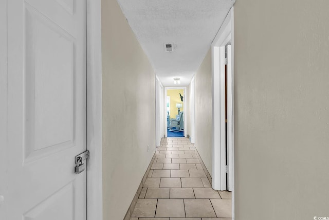 2511 S Ocean Blvd Unit 507G, Myrtle Beach, SC 29577 - corridor with light tile patterned flooring, baseboards, and a textured ceiling