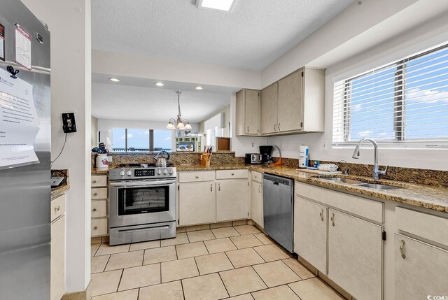 2511 S Ocean Blvd Unit 507G, Myrtle Beach, SC 29577 - kitchen with appliances with stainless steel finishes, a sink, a chandelier, dark stone counters, and recessed lighting