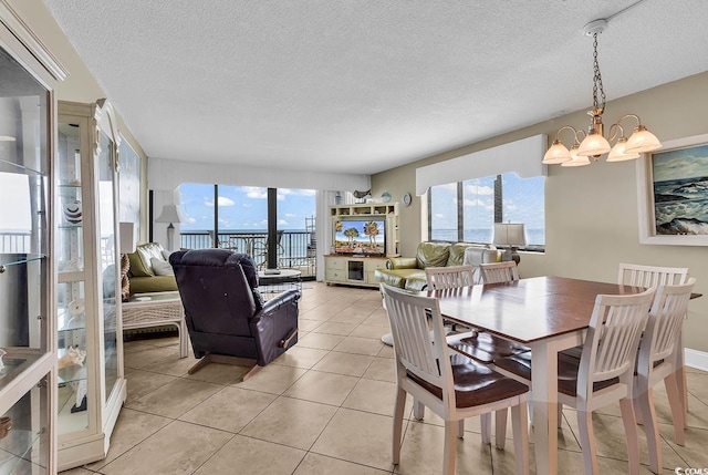 2511 S Ocean Blvd Unit 507G, Myrtle Beach, SC 29577 - dining space featuring a chandelier, light tile patterned floors, and a textured ceiling