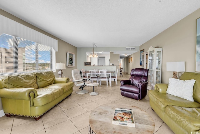2511 S Ocean Blvd Unit 507G, Myrtle Beach, SC 29577 - living room with a chandelier, light tile patterned floors, and a textured ceiling