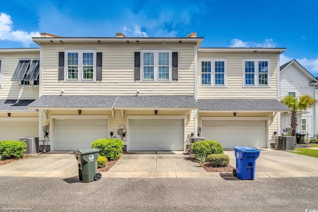 3477 Bristol Ln Unit 3477, Myrtle Beach, SC 29577 - view of property featuring a garage, central AC, driveway, and roof with shingles