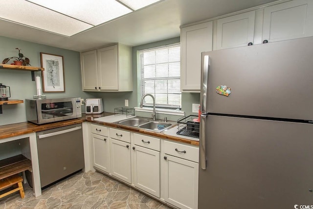 6610 Mallard View Pt, Myrtle Beach, SC 29588 - kitchen with stainless steel appliances, a sink, open shelves, light stone finish flooring, and wooden counters