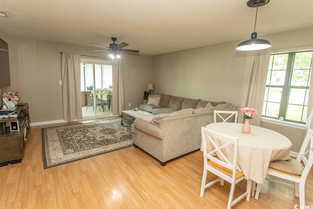 6610 Mallard View Pt, Myrtle Beach, SC 29588 - living room with light wood-type flooring, ceiling fan, a textured ceiling, and healthy amount of natural light