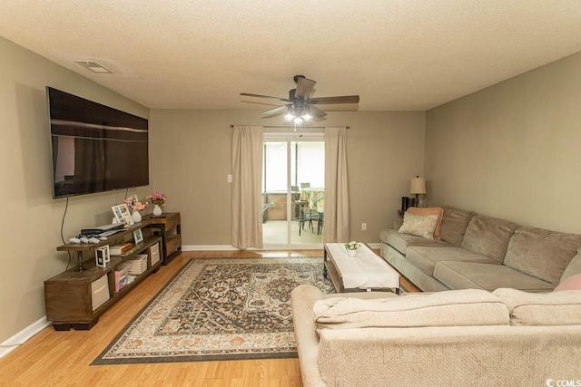 6610 Mallard View Pt, Myrtle Beach, SC 29588 - living room featuring wood finished floors, ceiling fan, a textured ceiling, and baseboards
