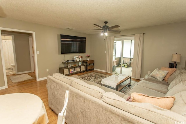 6610 Mallard View Pt, Myrtle Beach, SC 29588 - living area featuring light wood finished floors, a ceiling fan, baseboards, and a textured ceiling