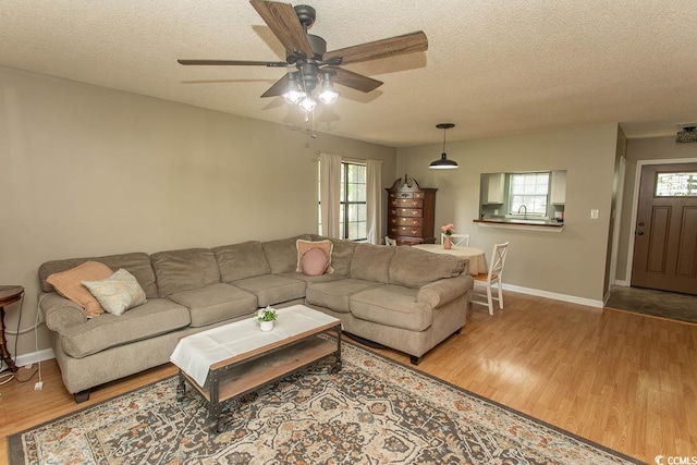 6610 Mallard View Pt, Myrtle Beach, SC 29588 - living room featuring wood finished floors, a textured ceiling, healthy amount of natural light, baseboards, and a ceiling fan
