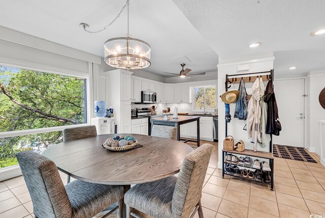423 Parker Dr Unit 334, Pawleys Island, SC 29585 - dining room with light tile patterned flooring, a chandelier, ceiling fan, and recessed lighting