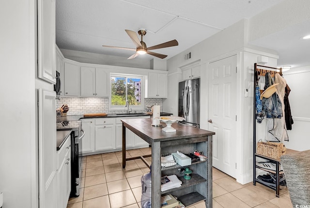 423 Parker Dr Unit 334, Pawleys Island, SC 29585 - kitchen featuring stainless steel appliances, ceiling fan, light tile patterned floors, open shelves, and backsplash