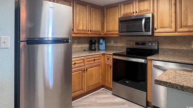 7100 N Ocean Blvd Unit 316, Myrtle Beach, SC 29572 - kitchen with stainless steel appliances, tasteful backsplash, and brown cabinets