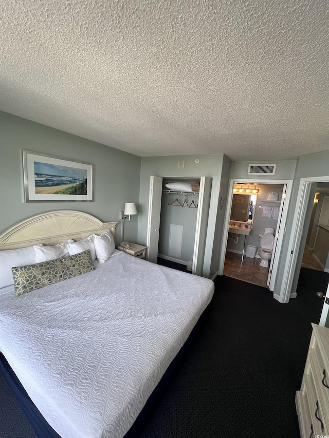 201 77th Ave N Unit 1133, Myrtle Beach, SC 29572 - bedroom with dark carpet, a textured ceiling, and a closet