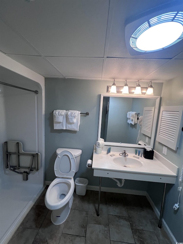 201 77th Ave N Unit 1133, Myrtle Beach, SC 29572 - bathroom with a sink, toilet, baseboards, and a paneled ceiling