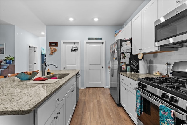 196 Cypress Tree Loop, Longs, SC 29568 - kitchen with appliances with stainless steel finishes, a sink, recessed lighting, white cabinets, and tasteful backsplash