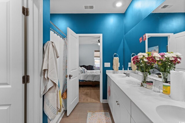 196 Cypress Tree Loop, Longs, SC 29568 - ensuite bathroom with double vanity, ceiling fan, and wood finished floors