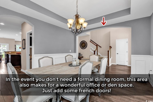 1227 Cypress Shadow Ct, Murrells Inlet, SC 29576 - dining area with a chandelier, arched walkways, stairway, a wainscoted wall, and wood finished floors