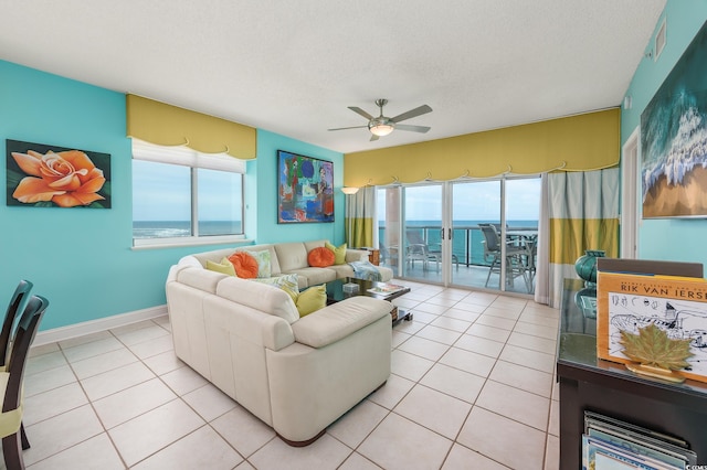 5700 N Ocean Blvd Unit Ph12, North Myrtle Beach, SC 29582 - living room with ceiling fan, healthy amount of natural light, a water view, a textured ceiling, and light tile patterned floors