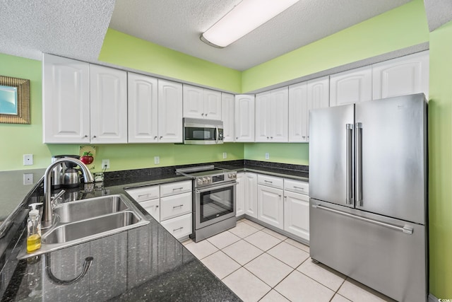 5700 N Ocean Blvd Unit Ph12, North Myrtle Beach, SC 29582 - kitchen with stainless steel appliances, a sink, white cabinets, and a textured ceiling