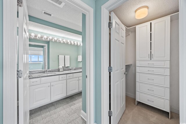 5700 N Ocean Blvd Unit Ph12, North Myrtle Beach, SC 29582 - full bath featuring double vanity, a textured ceiling, and baseboards