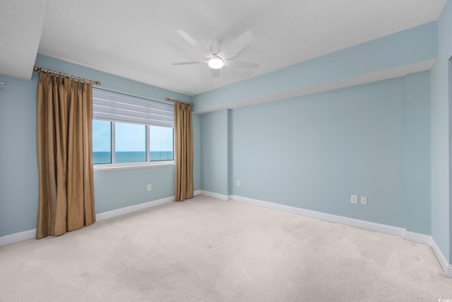 5700 N Ocean Blvd Unit Ph12, North Myrtle Beach, SC 29582 - carpeted spare room featuring a water view, a ceiling fan, baseboards, and a textured ceiling