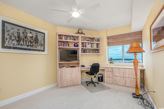 5700 N Ocean Blvd Unit Ph12, North Myrtle Beach, SC 29582 - carpeted home office with built in study area, ceiling fan, and baseboards