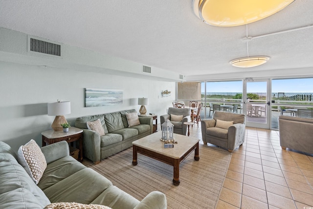 5700 N Ocean Blvd Unit Ph12, North Myrtle Beach, SC 29582 - living room with a textured ceiling and light tile patterned floors