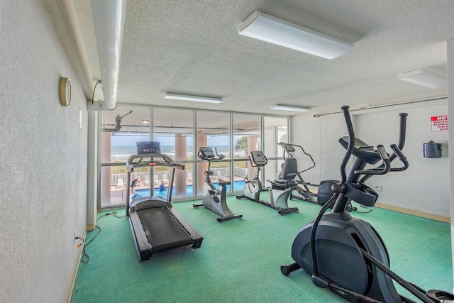 5700 N Ocean Blvd Unit Ph12, North Myrtle Beach, SC 29582 - gym featuring a textured ceiling, carpet floors, and a textured wall