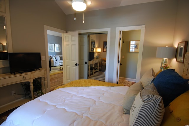 390 Lands End Blvd Unit 4-201, Myrtle Beach, SC 29572 - bedroom with vaulted ceiling, a closet, wood finished floors, and baseboards