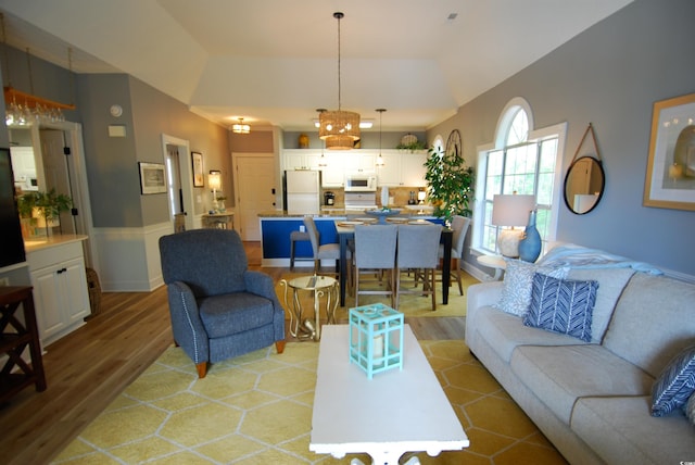 390 Lands End Blvd Unit 4-201, Myrtle Beach, SC 29572 - living area with light wood finished floors, vaulted ceiling, a chandelier, and wainscoting