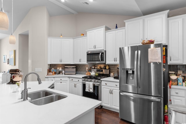 765 Berkshire Ave, Myrtle Beach, SC 29577 - kitchen with appliances with stainless steel finishes, a sink, vaulted ceiling, tasteful backsplash, and white cabinetry