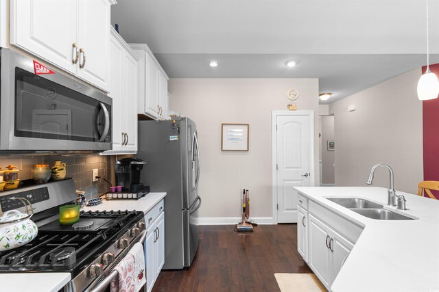 765 Berkshire Ave, Myrtle Beach, SC 29577 - kitchen with stainless steel appliances, a sink, baseboards, dark wood-type flooring, and light countertops
