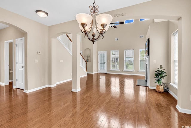 126 Dreamland Dr, Murrells Inlet, SC 29576 - unfurnished dining area featuring arched walkways, wood finished floors, stairs, and a chandelier