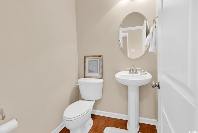 126 Dreamland Dr, Murrells Inlet, SC 29576 - half bathroom with toilet, wood finished floors, baseboards, and a sink