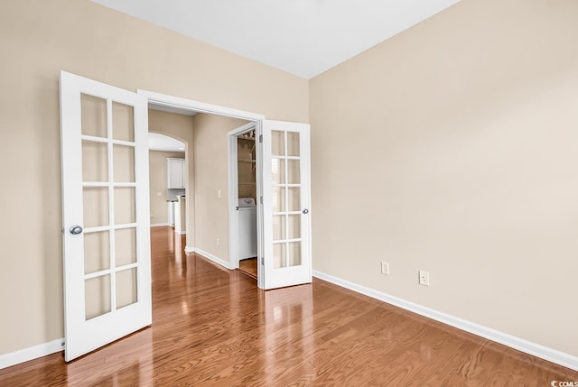 126 Dreamland Dr, Murrells Inlet, SC 29576 - unfurnished room featuring french doors, arched walkways, baseboards, and wood finished floors