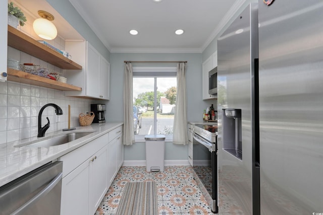 800 S 9th Ave S Unit A-1, North Myrtle Beach, SC 29582 - kitchen featuring appliances with stainless steel finishes, a sink, baseboards, white cabinetry, and decorative backsplash