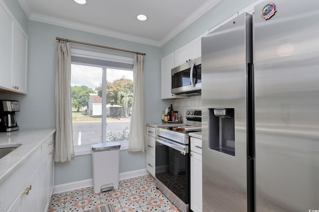 800 S 9th Ave S Unit A-1, North Myrtle Beach, SC 29582 - kitchen with appliances with stainless steel finishes, baseboards, white cabinets, decorative backsplash, and recessed lighting