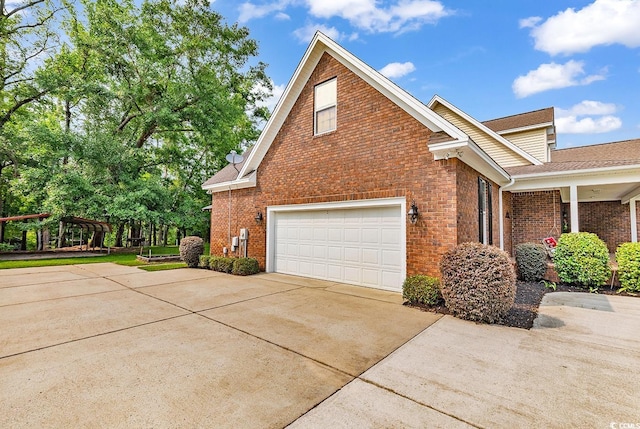 6161 Inman Cir, Conway, SC 29526 - view of side of home featuring brick siding, an attached garage, concrete driveway, and a shingled roof