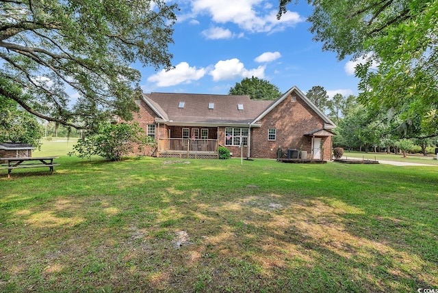 6161 Inman Cir, Conway, SC 29526 - rear view of house featuring brick siding, a wooden deck, a yard, and central AC unit