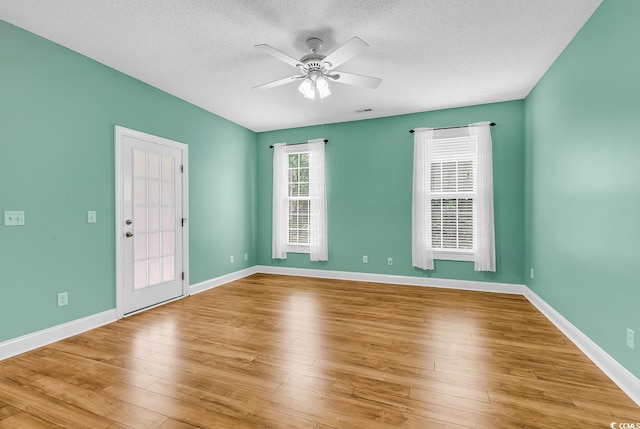6161 Inman Cir, Conway, SC 29526 - empty room with a textured ceiling, a ceiling fan, baseboards, and wood finished floors