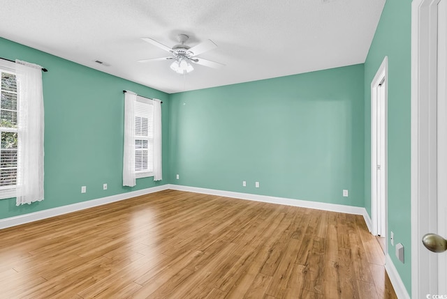 6161 Inman Cir, Conway, SC 29526 - unfurnished room with light wood-type flooring, ceiling fan, baseboards, and a textured ceiling